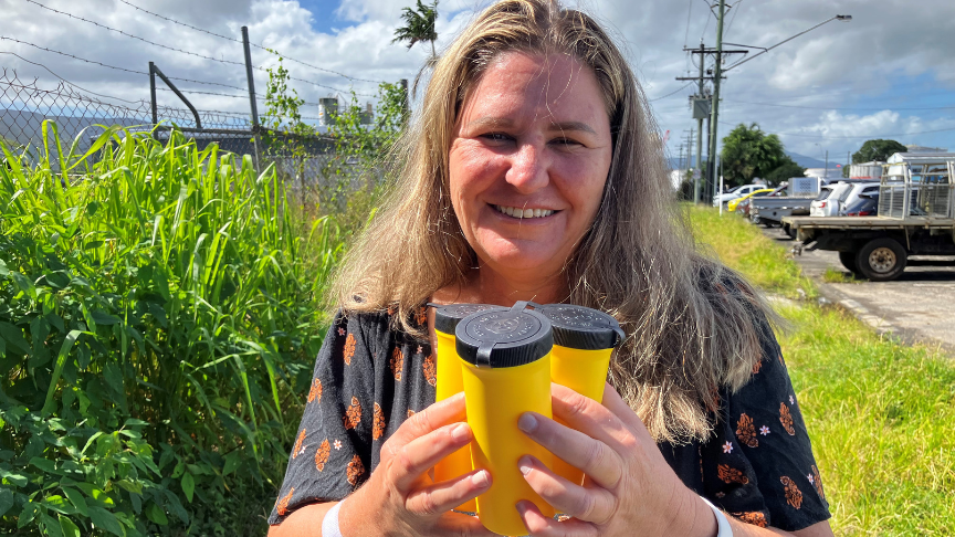 Health worker holding syringe disposal containers