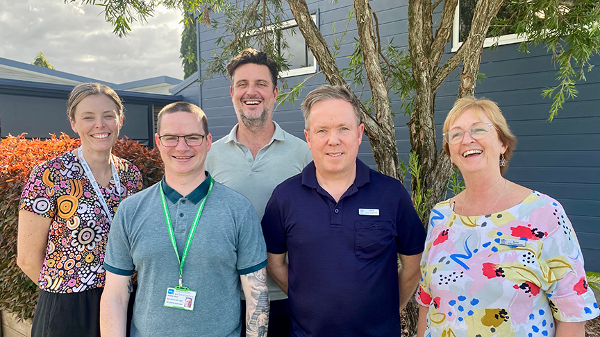 Group photo of team members standing outside Gordonvale Hospital