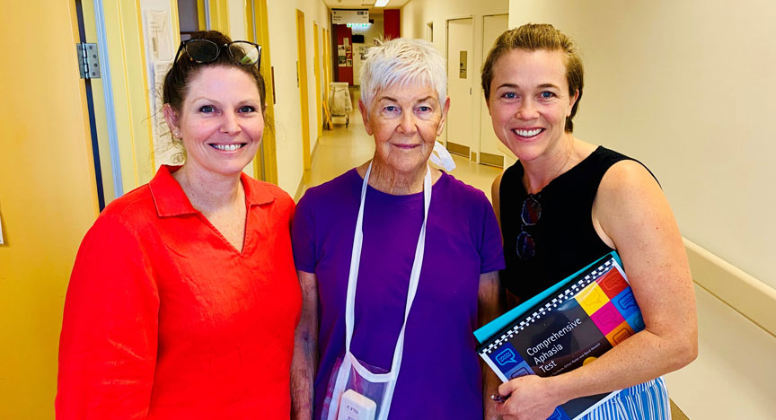Group photo of a patient and two team members standing inside Cairns Hospital