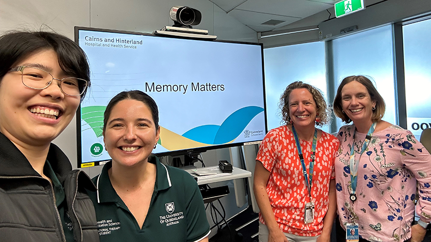 Four women taking a selfie in front of a videoconference machine that has 'Memory Matters' visible on the screen